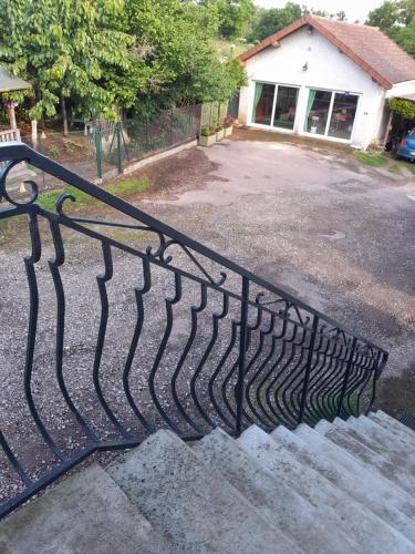 a metal railing on a staircase in front of a building at CHAMBRES D HÔTES AU P'TIT BONHEUR CAMPAGNARD in Jarnosse