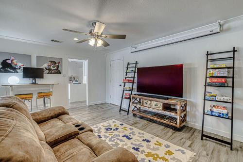 a living room with a couch and a flat screen tv at Family-Friendly 3BR w Private Pool & BBQ in SW Austin in Bee Cave