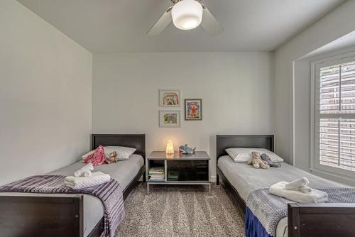 a bedroom with two beds with stuffed animals on them at Family-Friendly 3BR w Private Pool & BBQ in SW Austin in Bee Cave