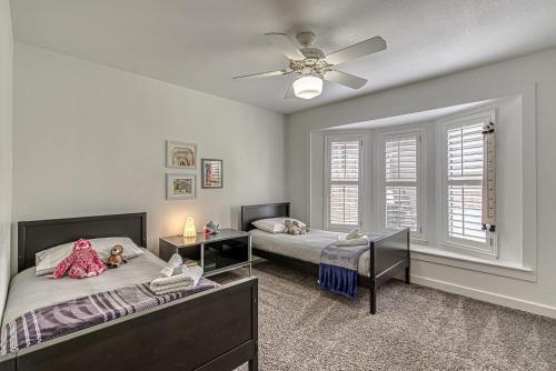 a bedroom with two beds and a ceiling fan at Family-Friendly 3BR w Private Pool & BBQ in SW Austin in Bee Cave