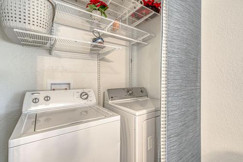 a laundry room with a washer and dryer at Family-Friendly 3BR w Private Pool & BBQ in SW Austin in Bee Cave