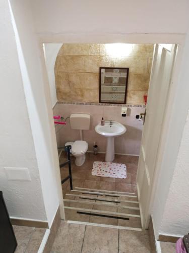 a small bathroom with a sink and a toilet at B&B Sikelia in Terrasini