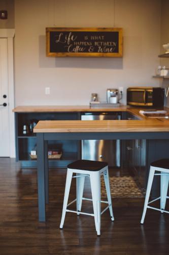 a kitchen with a counter and two stools at a table at The Market Lofts in Dundee