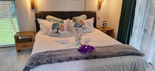 a bed with two dolls sitting on top of it at Tree Living in Krugersdorp