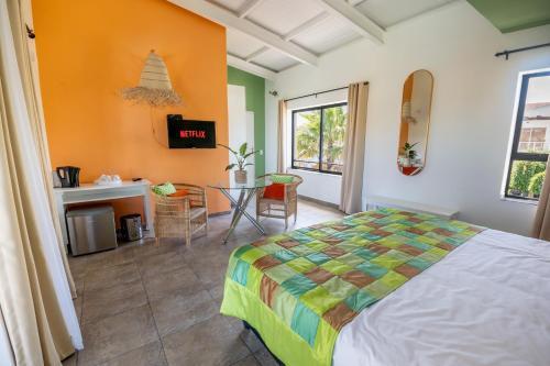 a bedroom with a bed and a table in it at Cape Town 4U Guesthouse in Cape Town