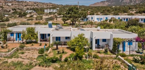 an aerial view of a white house with blue windows at Pleiades Apartments in Lefkos Karpathou