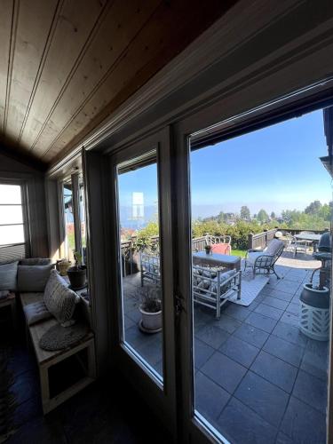 a screened in porch with sliding glass doors at 5 bedroom Spectacular view & charming house in Vollen centre in Vollen