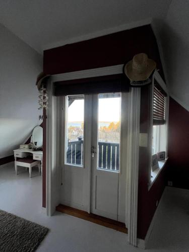 a room with a door leading to a balcony at 5 bedroom Spectacular view & charming house in Vollen centre in Vollen