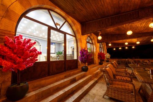 a dining room with chairs and a large window at hotels crazy horse in Ortahisar