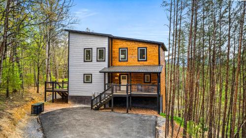a house in the middle of the woods at Mountain Bliss by Avada Properties in Sevierville