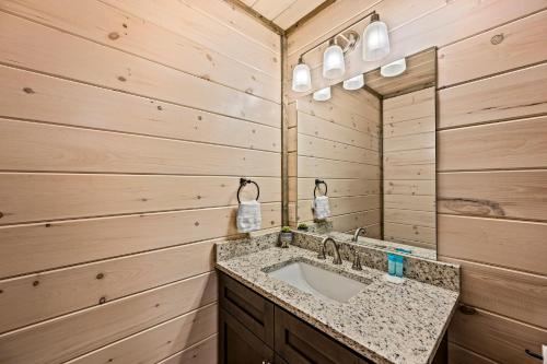 a bathroom with a sink and a mirror at Mountain Bliss by Avada Properties in Sevierville