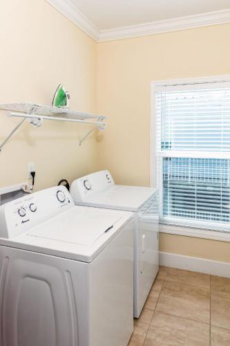 a white laundry room with a washer and dryer at #1beautiful 4 Bed 3 Bath Pool Home W Free Dock in Marathon