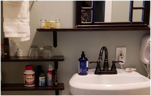 a bathroom with a sink and a toilet and a mirror at Cabernet House, an Old World Inn in Napa