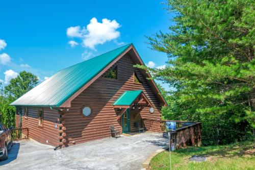 a log cabin with a green roof at My Pigeon Forge Cabin in Pigeon Forge