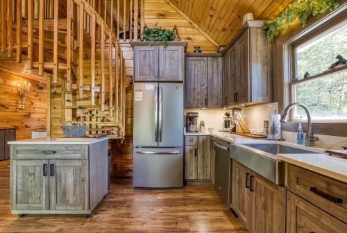 a kitchen with wooden cabinets and a refrigerator at My Pigeon Forge Cabin in Pigeon Forge