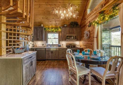 a kitchen with a table and chairs and a chandelier at My Pigeon Forge Cabin in Pigeon Forge