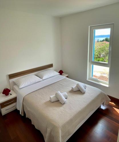 a bedroom with a large bed with two towels on it at Apartment on the beach Mare in Makarska