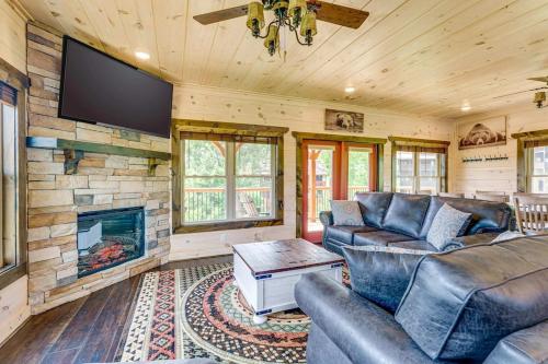 a living room with a couch and a fireplace at Misty Mountain Stop by Avada Properties in Pigeon Forge