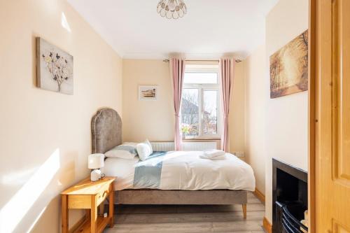 a bedroom with a bed and a fireplace at Lime Tree Cottage Foxford County Mayo in Mayo