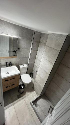 a bathroom with a white toilet and a sink at Villaggio View in Kariá