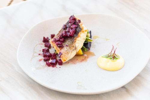 a white plate with a piece of food on it at The Westin Resort, Costa Navarino in Romanós