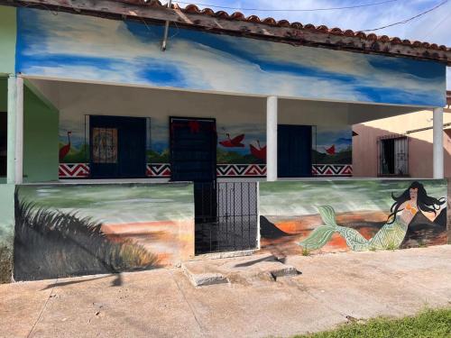 a building with a painting on the side of it at Canto da Sereia - Casa in Soure