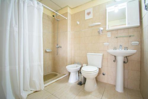 a bathroom with a toilet and a sink at Terminal Suites El Calafate in El Calafate
