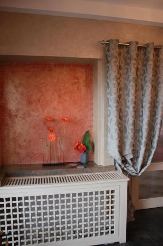 a room with a window with a curtain and flowers at Hôtel Restaurant le Panorama in Évian-les-Bains