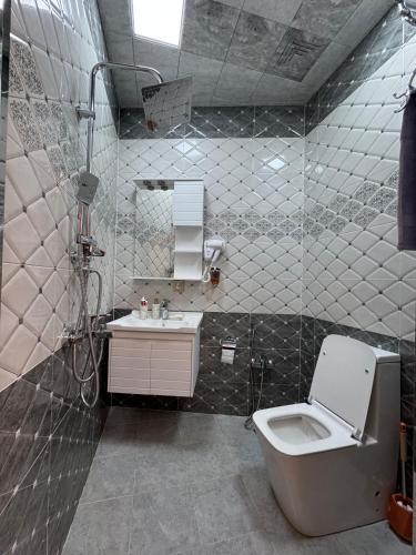 a bathroom with a toilet and a sink at Burj Sheki in Sheki