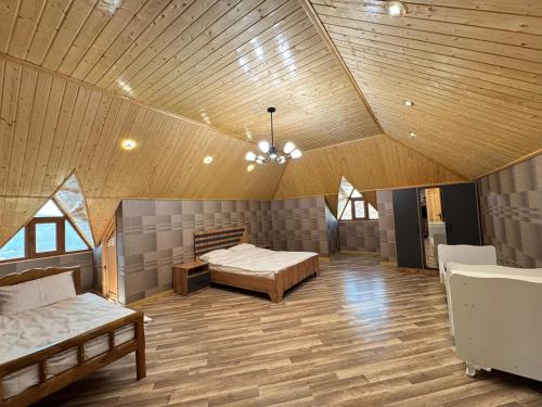a large room with two beds and a ceiling at Burj Sheki in Sheki
