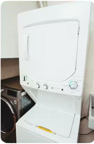 a white microwave oven sitting on top of a counter at Departamentos Los Cabos 1 in San José del Cabo