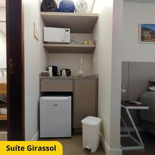 a small kitchen with a sink and a toilet in a room at Bela Vista Hospedagem in Joinville