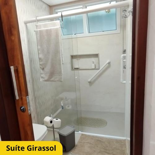 a bathroom with a glass shower with a toilet at Bela Vista Hospedagem in Joinville