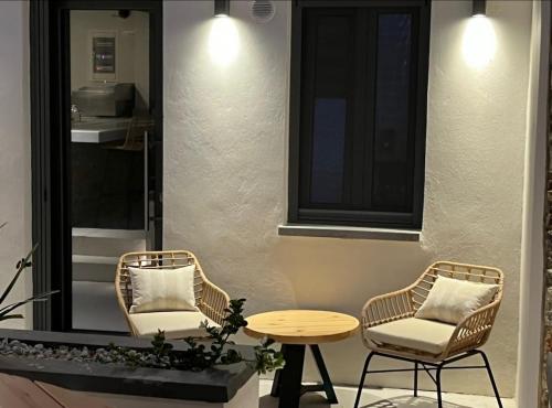 two chairs and a table on a patio at Venetian gem in neapolitan with private courtyard in Neápolis