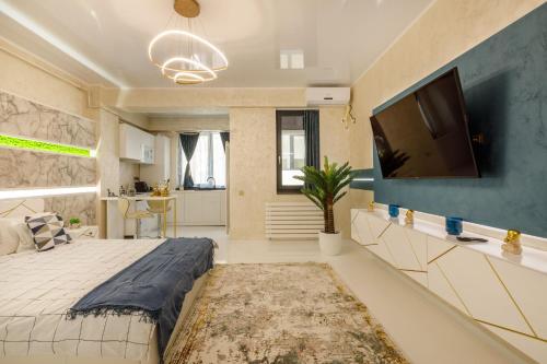 a bedroom with a large bed and a flat screen tv at HF - Mamaia Nord Building Resort in Mamaia Sat/Năvodari