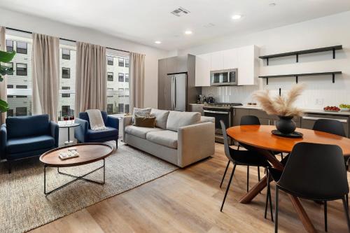 a living room with a couch and a table at Luxury Apartments by Hyatus at Boston Everett in Everett