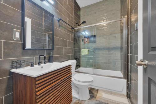 a bathroom with a toilet and a sink and a shower at Serenity House 2BR Central Location in ATL in Atlanta