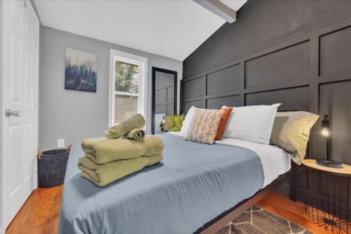 a bedroom with a large bed with towels on it at Serenity House 2BR Central Location in ATL in Atlanta