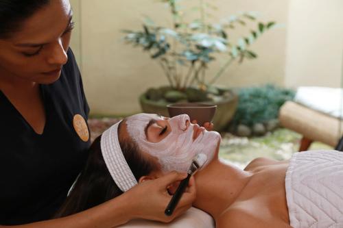 a woman shaving a womans face with a shaving brush at InterContinental Costa Rica at Multiplaza Mall by IHG in San José