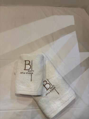 two towels sitting on top of a table at Haraki Beauty in Haraki
