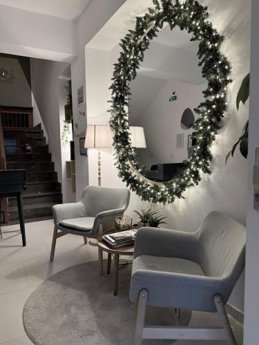 a living room with a christmas wreath and a mirror at Villa Vera in Salerno