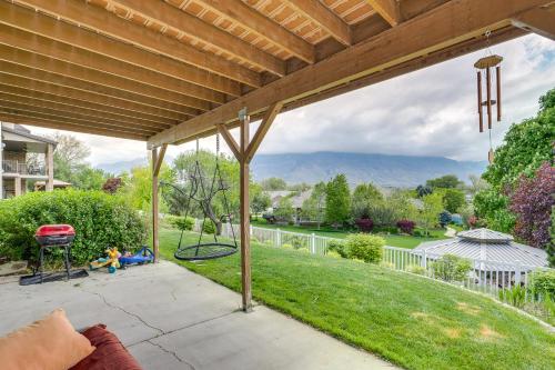 a porch with a swing and a playground at 6 Mi to Grove Creek Canyon Trail Abode with Views in American Fork