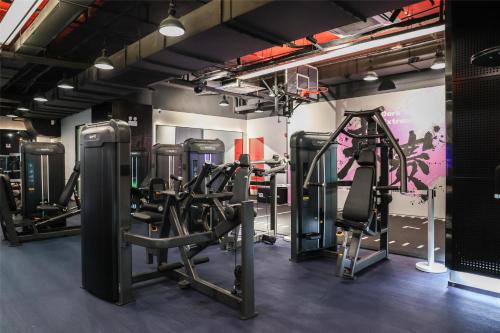 a gym with several tread machines in a room at Kempinski The One Suites Hotel Shanghai Downtown in Shanghai