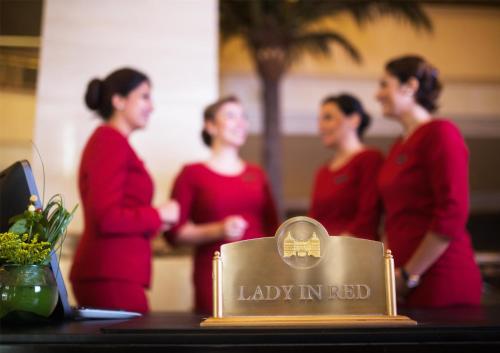 a group of women standing around a table with a lady inspired plaque at Royal Maxim Palace Kempinski Cairo in Cairo