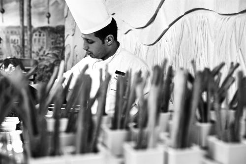 a man in a chefs hat standing next to a group of knives at Royal Maxim Palace Kempinski Cairo in Cairo