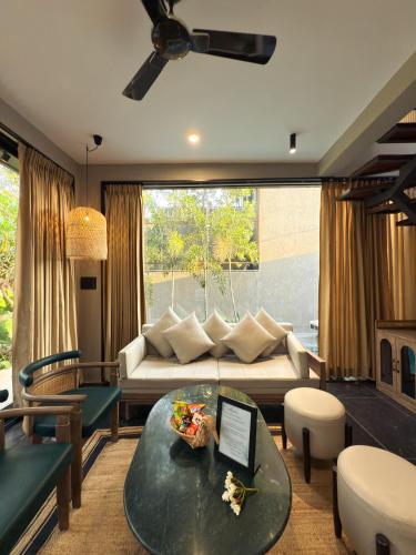 a living room with a couch and a table at The Bali House in Bhopal