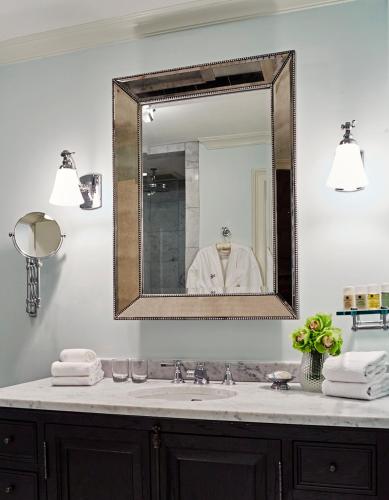 a bathroom with a sink and a mirror at Dunhill Hotel in Charlotte