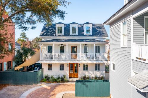 a white house with a blue roof and a balcony at The Inn at 257 in Charleston
