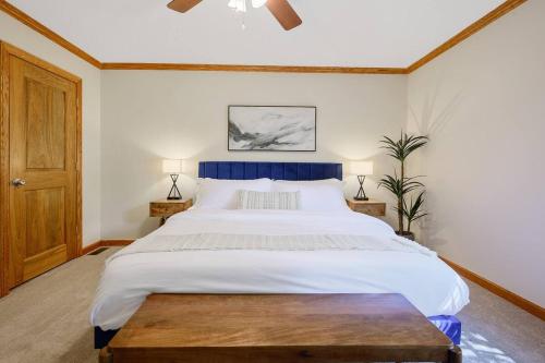 a bedroom with a large bed with a blue headboard at 4 Beds ,King Bed, Tvs, Kids essentials, office, Grill, Crib, in Bond park ,PNC Arena in Cary