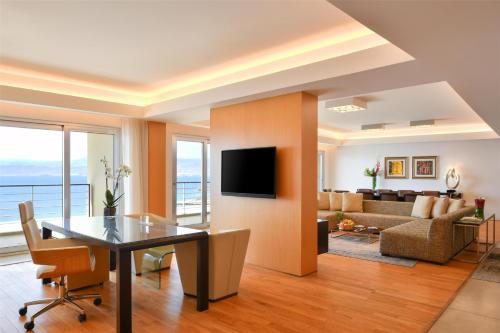 a living room with a dining table and a couch at Kempinski Hotel Aqaba in Aqaba